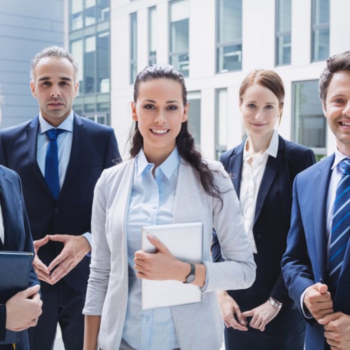 confident-businesspeople-standing-outside-office-building